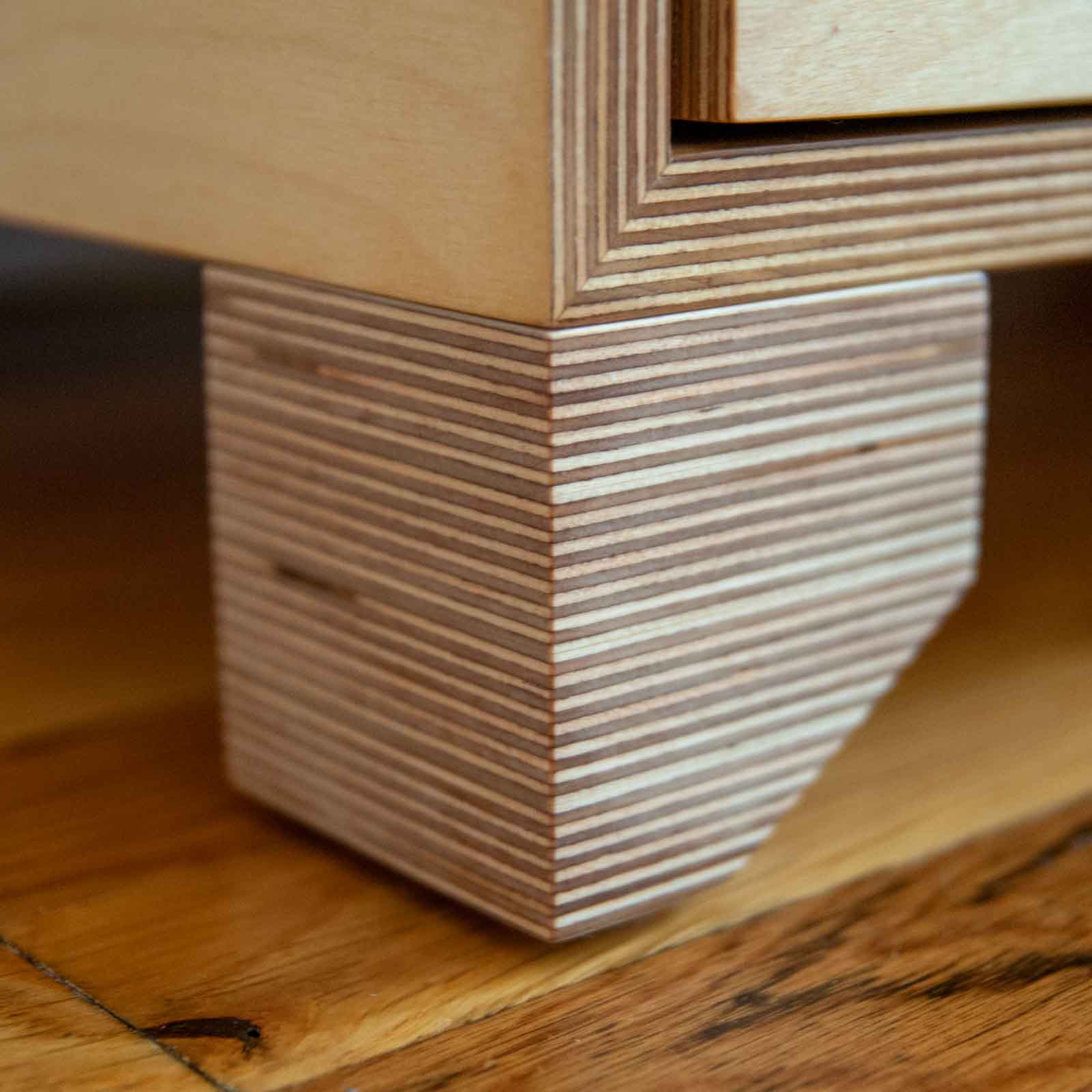 Detail of dresser feet showing baltic birch layers in a cube shape