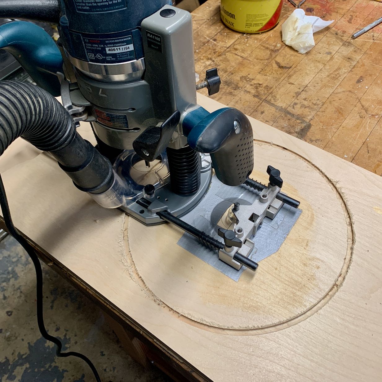 Build process photo of a router cutting a circle for the speaker baffle