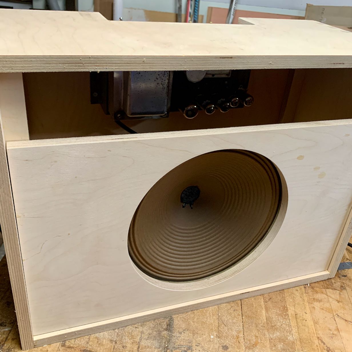Build process photo showing unfinished cabinet assembled with speaker and amp