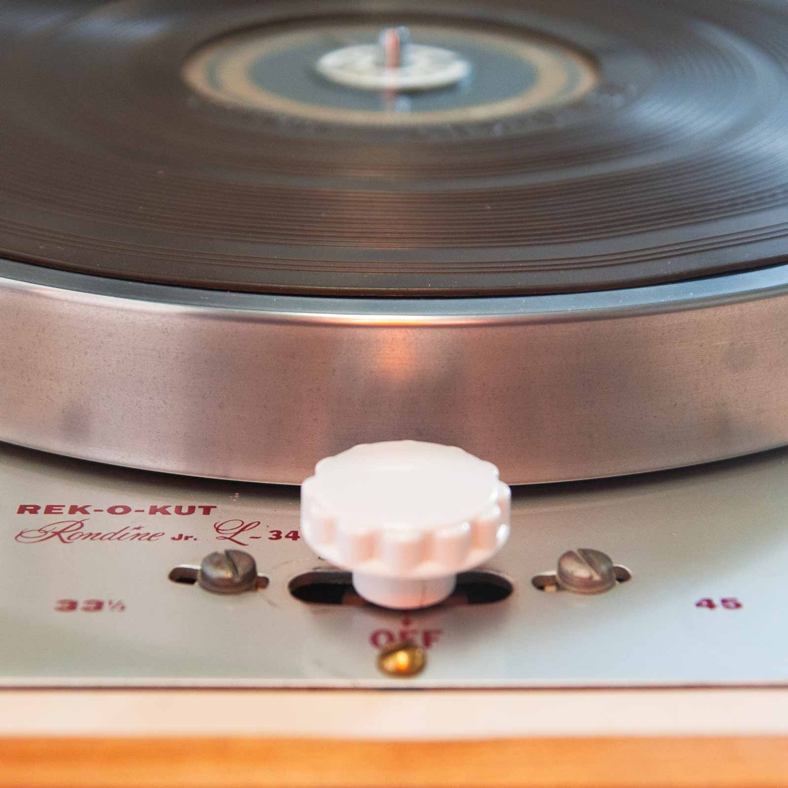 Detail showing turntable switch knob, heavy platter, and rubber slipmat